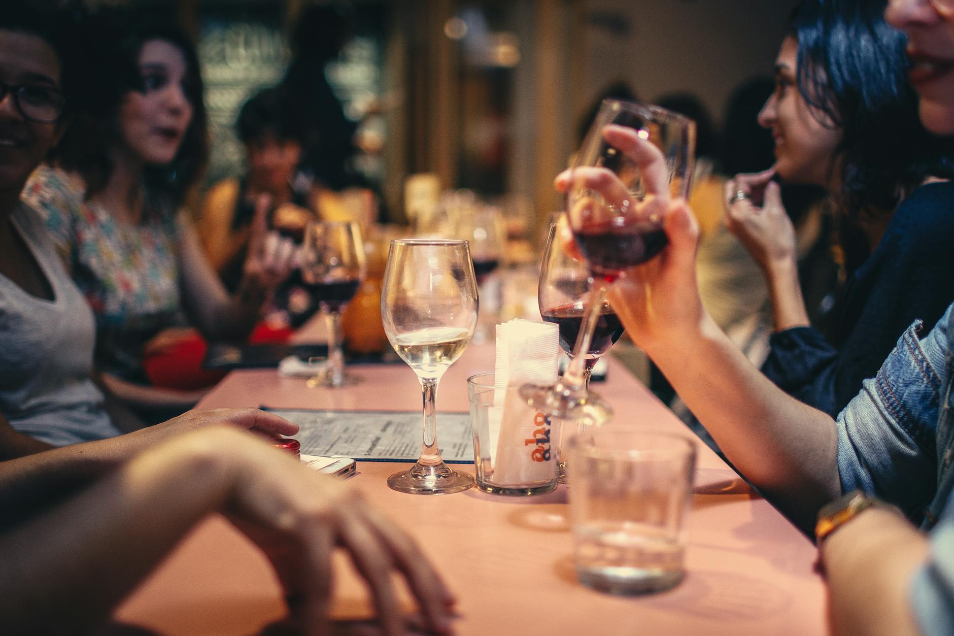 Restaurant diners socializing over wine